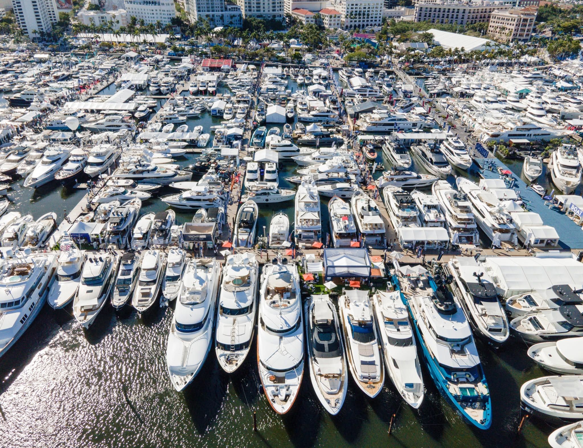 Aerial view of a bustling marina packed with luxurious yachts and boats.