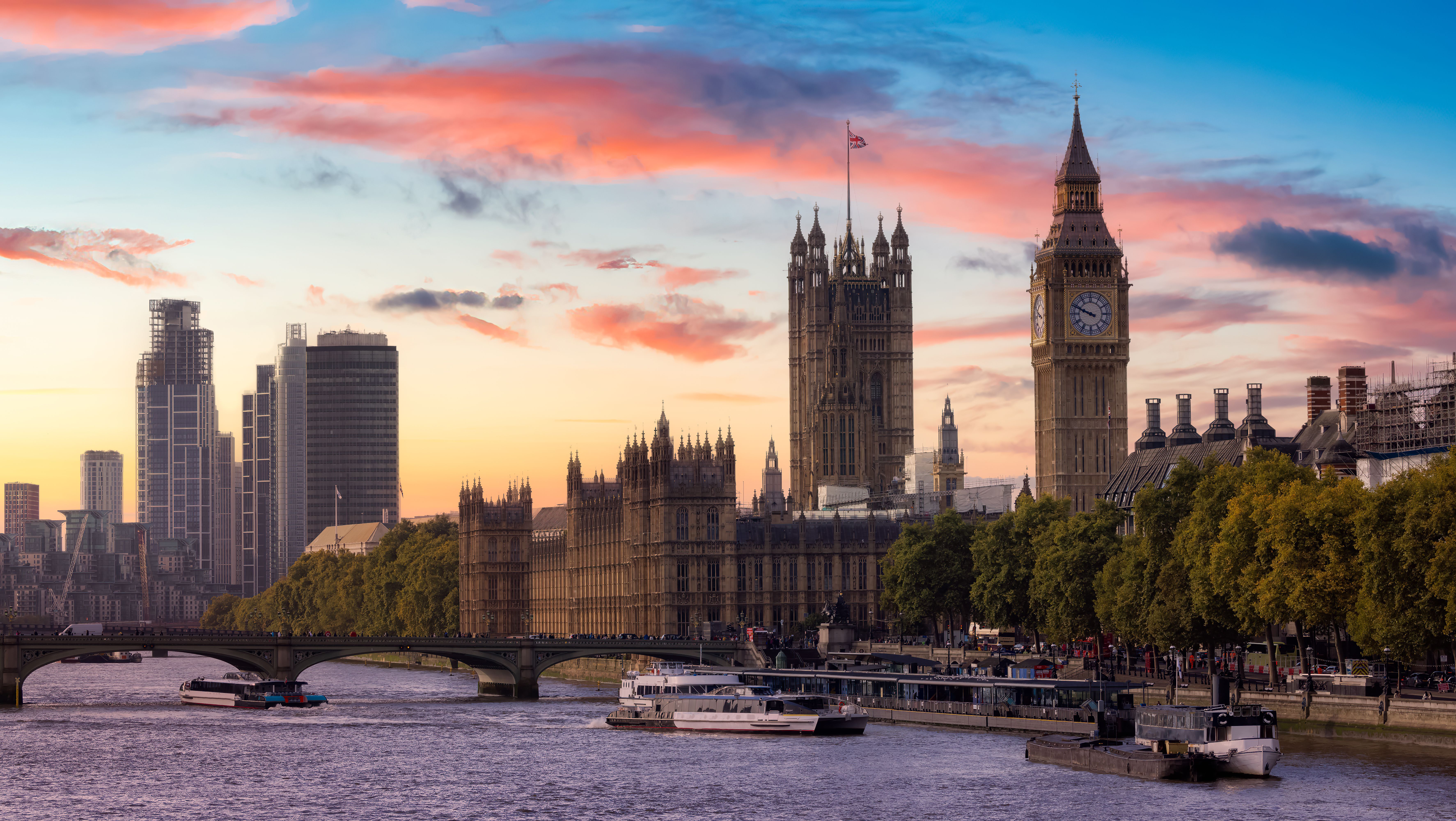 Big Ben and the Houses of Parliament overlook the River Thames at sunset.