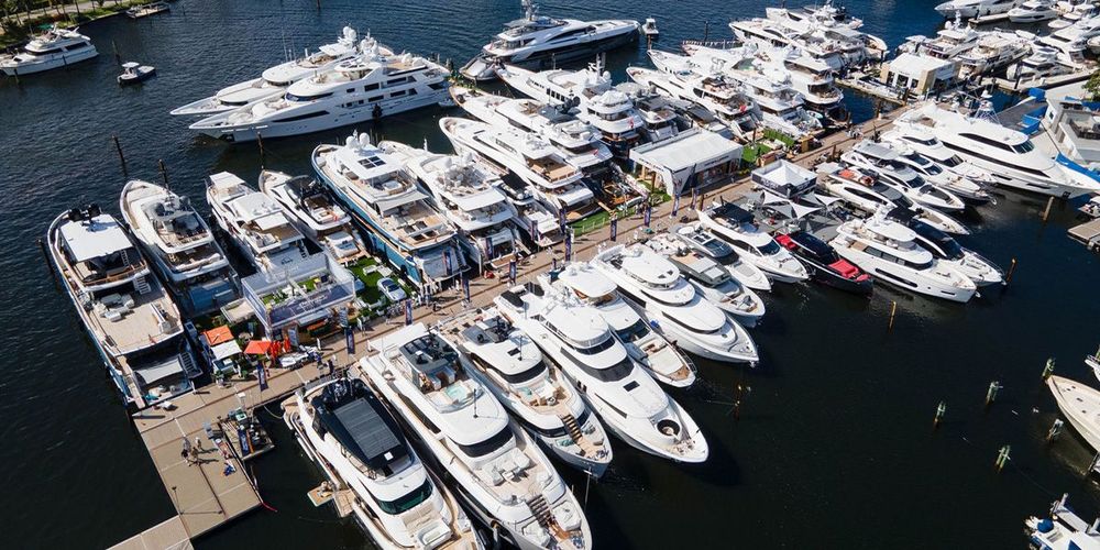 Crowded marina seen from above, filled with numerous luxury yachts docked along piers.