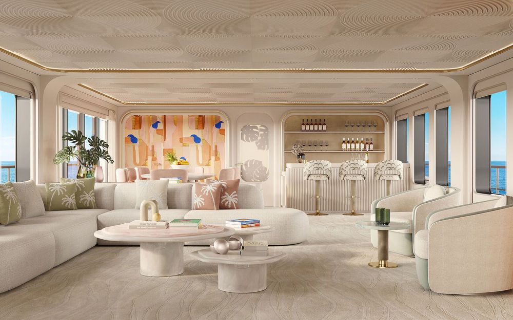 Spacious, luxurious yacht lounge featuring a white sofa, modern bar, and panoramic ocean views.
