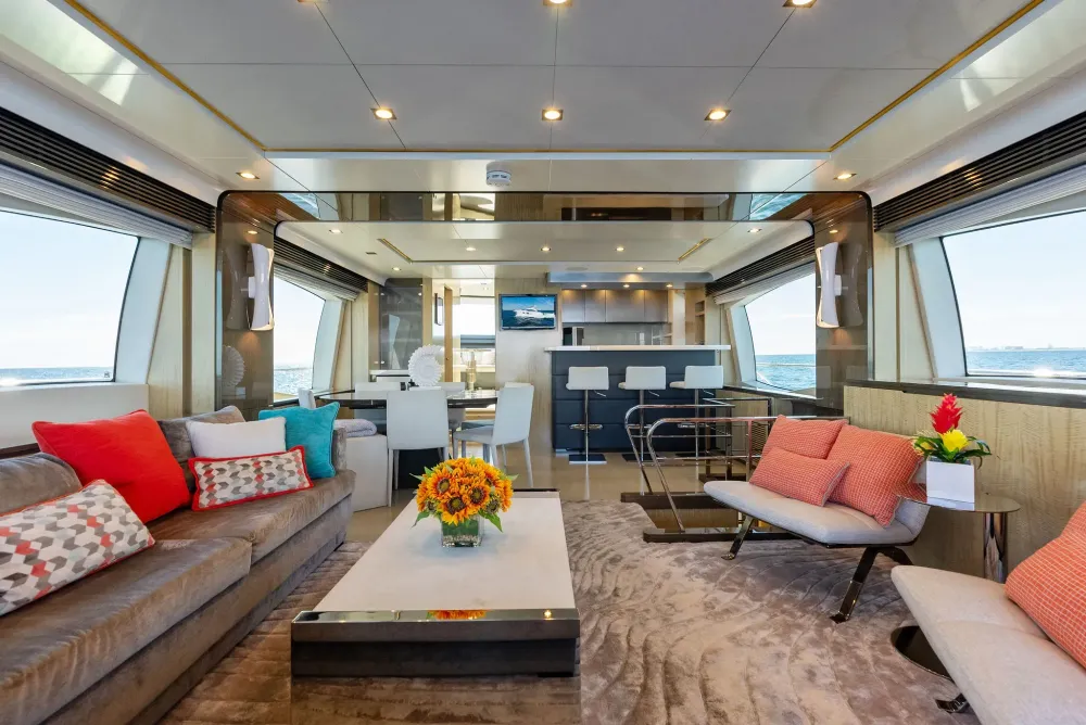 Luxurious yacht interior with a modern living area, dining space, and panoramic ocean views.