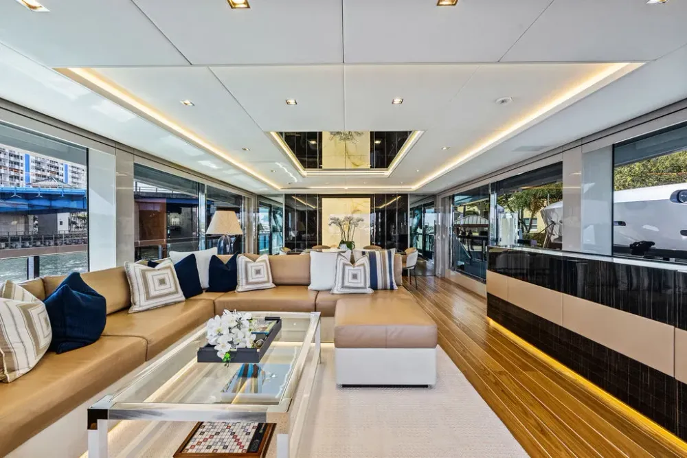 Elegant yacht interior featuring a living area, dining space, and bar with ocean views.