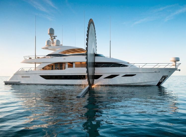 A luxurious white yacht floats on calm blue water with a large reflective disc sculpture.